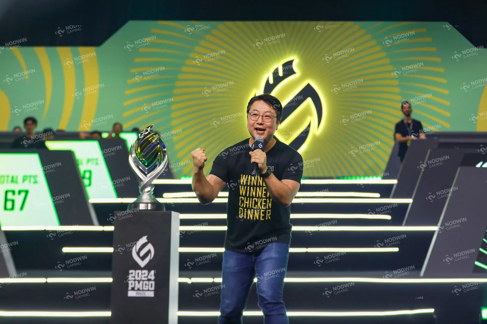 Presenter raising the PUBG Mobile trophy on stage